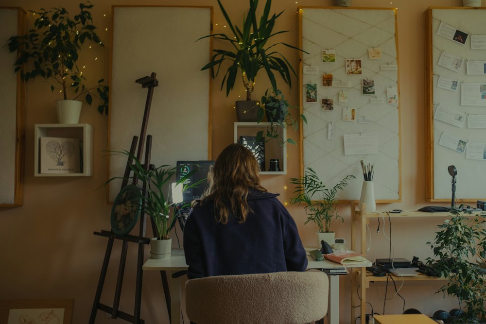 Working at a desk surrounded by plants
