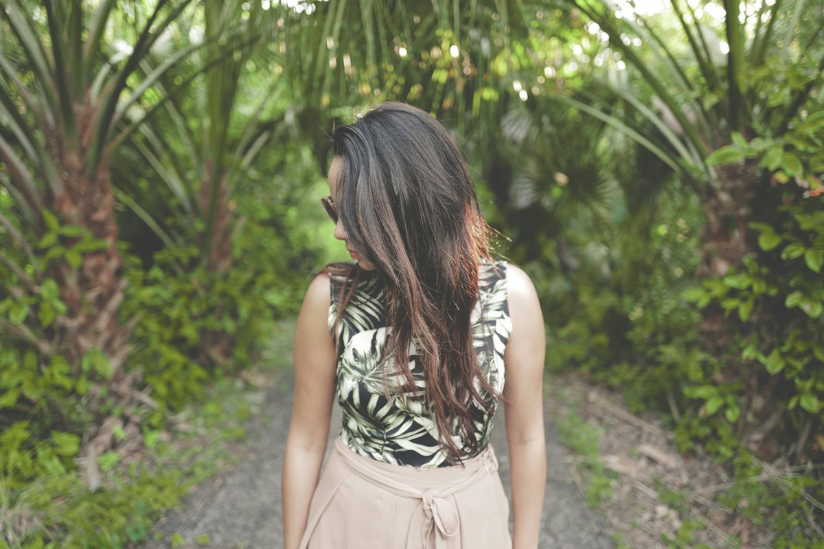 A woman walking a forest trail on her own